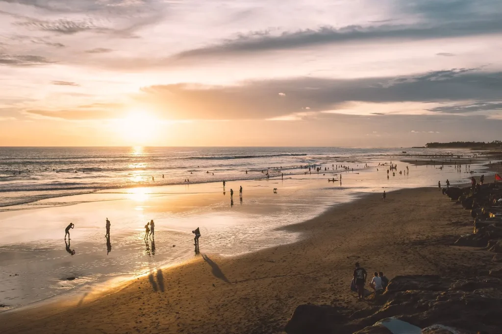 Kuta Bali beach with surfers sunset views and lively atmosphere