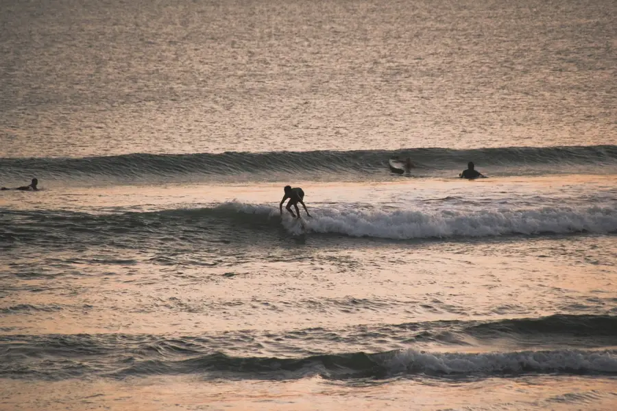 Surfing on canggu beach with sunset