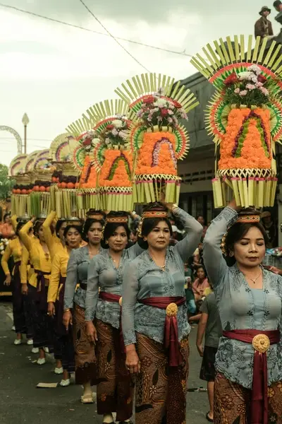 Balinese women bring offering to temple in bali